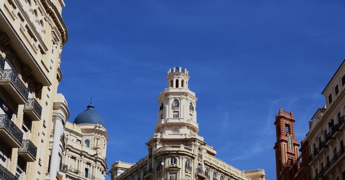 Hostal Moratin, Valencia — 80 Metres from Plaza del Ayuntamiento Iconic architectural landmarks of Valencia, Spain under a bright blue sky.