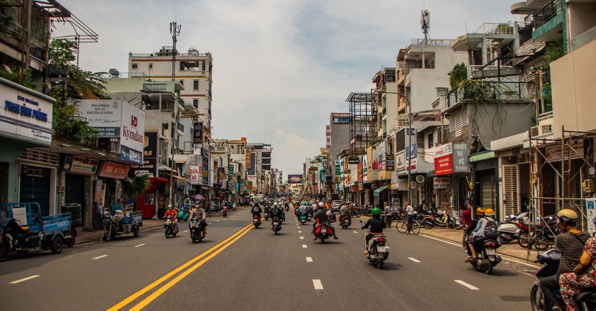 Ho Chi Minh City travel guide: warm weather, easy transport, layered history Motorcycles fill a lively street in Ho Chi Minh City, Vietnam, with bustling energy and vibrant architecture.