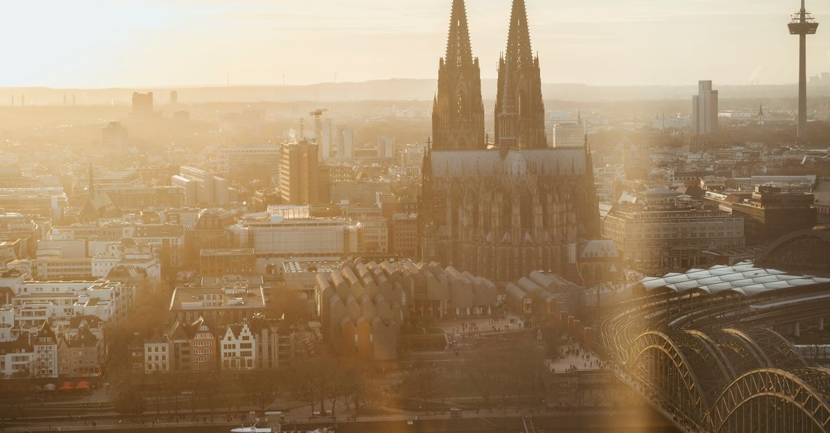 CityClass Hotel Alter Markt in Cologne: Steps from the Famous Cathedral Aerial view of Cologne Cathedral with golden sunrise over the Rhine River.