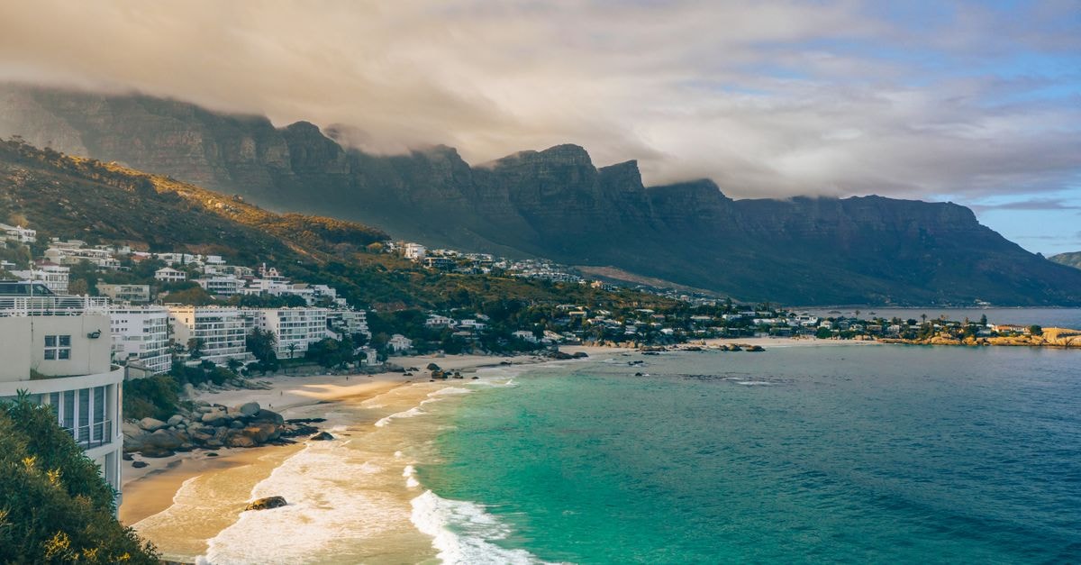 Rawson Travel Guide: Planning Tips, Costs and Things to Do Beautiful coastal view of Cape Town with mountains and beach under dramatic sky.