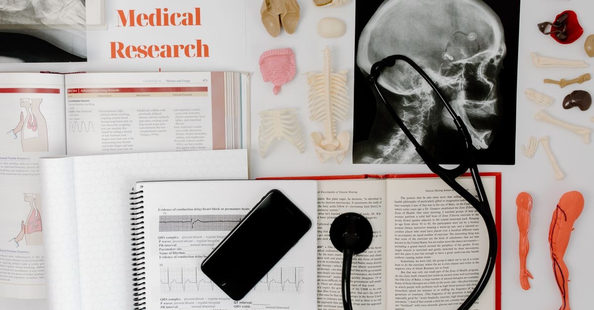Eli Lilly to Acquire Merida Biosciences for Up to $2.875 Billion Flat lay of medical research materials with a stethoscope and anatomical models.