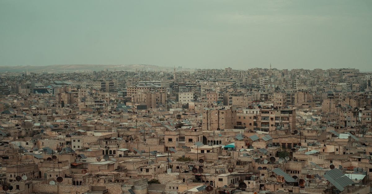 Sadr City Travel Guide: Planning Tips, Costs and Things to Do A wide aerial view of the densely packed urban landscape of Aleppo, Syria.