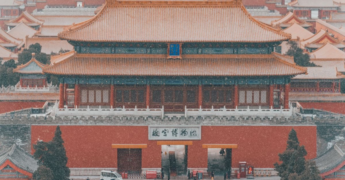 Kaifeng Travel Guide: An Easygoing Look at an Ancient Capital Aerial shot of the Forbidden City covered in snow, highlighting the ancient architecture in Beijing, China.
