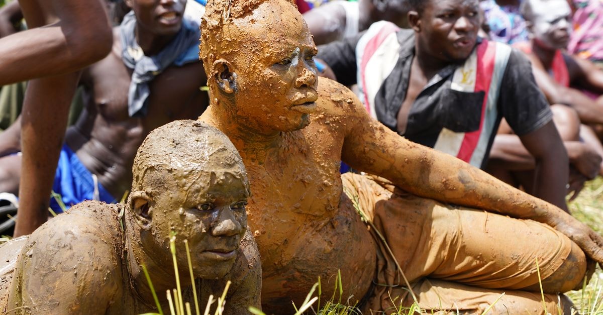A Slow-Travel Guide to Kara, Togo's Northern Heart Vibrant cultural ceremony in Lama-Kara, Togo, featuring mud-covered participants enjoying the festival.