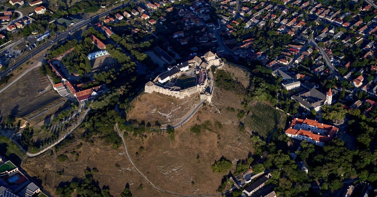 Ptuj Travel Guide: Slovenia's Oldest Town, From Castle Hill to Wine Hills Aerial shot showcasing a historic hilltop castle with a surrounding city landscape.