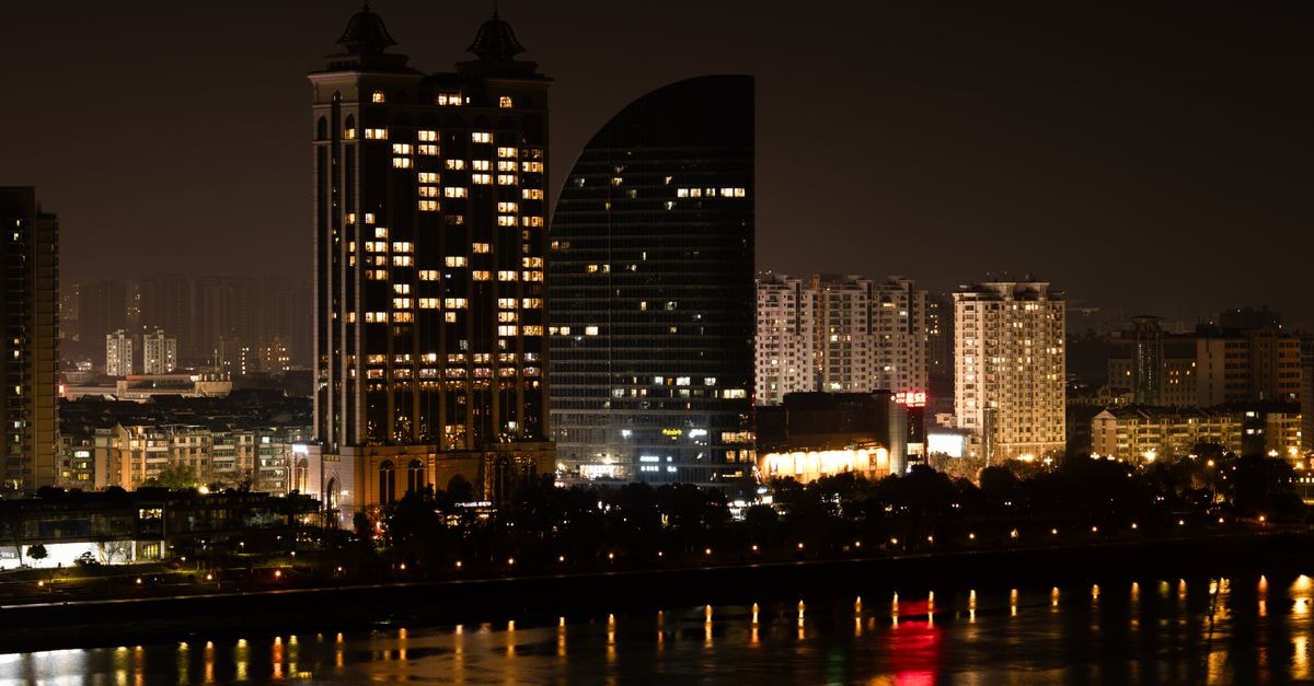 Holiday Inn Express Shijiazhuang High-tech Zone: Metro-Adjacent Base for Hi-Tech Discovery Stunning nighttime view of Hangzhou's illuminated skyline reflecting on the river.