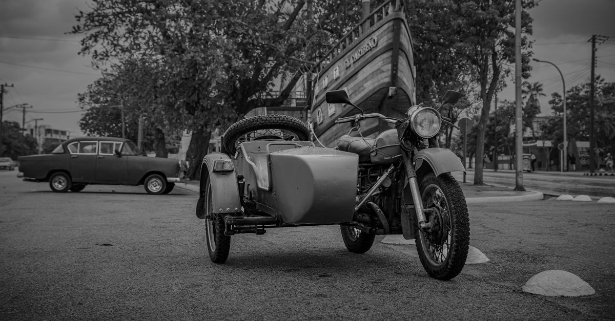 Hotel Rio San Juan in Matanzas: A Colonial-Style Stay Near Plaza de La Vigia Classic motorcycle with sidecar parked on a quiet street in Varadero, Matanzas, Cuba.