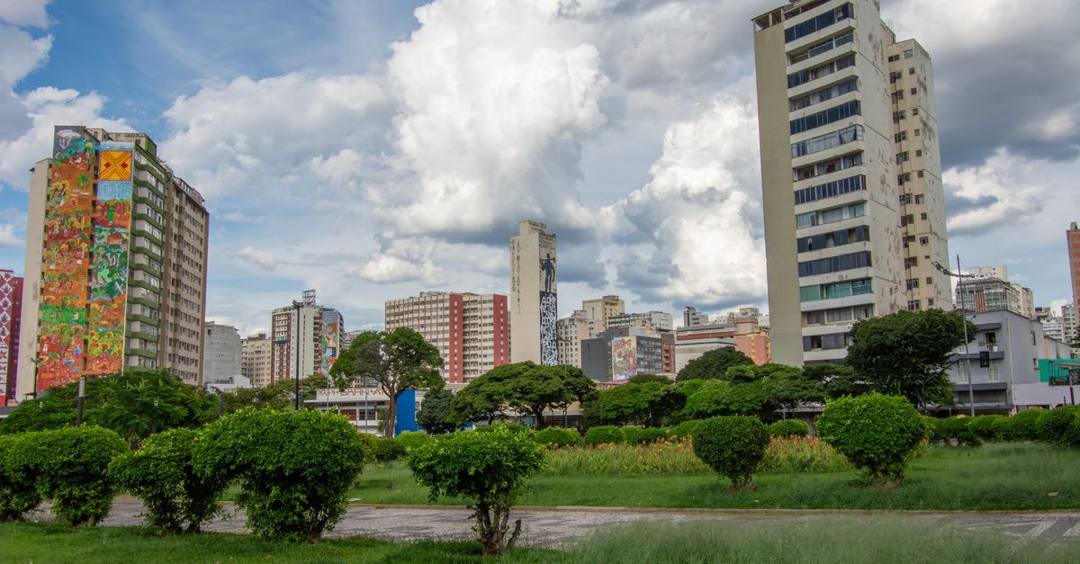 Skyline of Belo Horizonte featuring modern high-rise buildings under a dramatic sky.