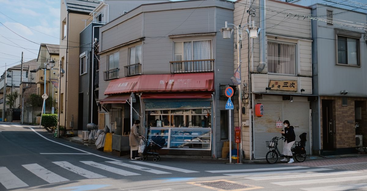 Saitama Travel Guide: A Quieter Crossroads North of Tokyo Peaceful street scene in Tokyo, Japan, featuring traditional shops and pedestrians.