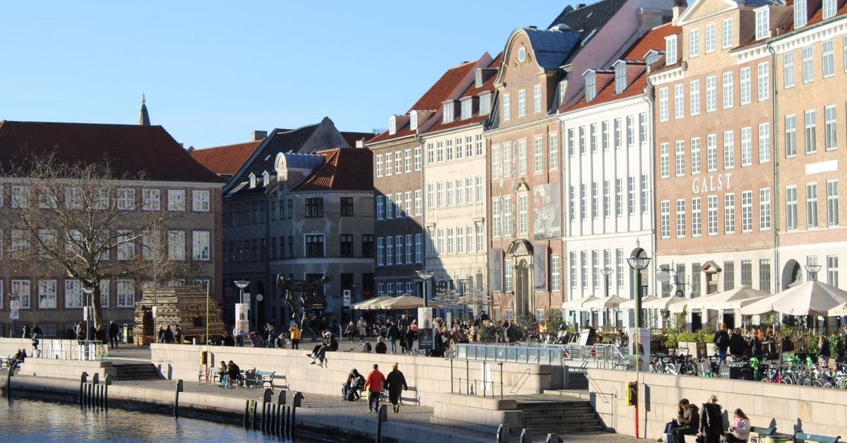 A sunny winter day along Copenhagen's waterfront, showcasing historic architecture.