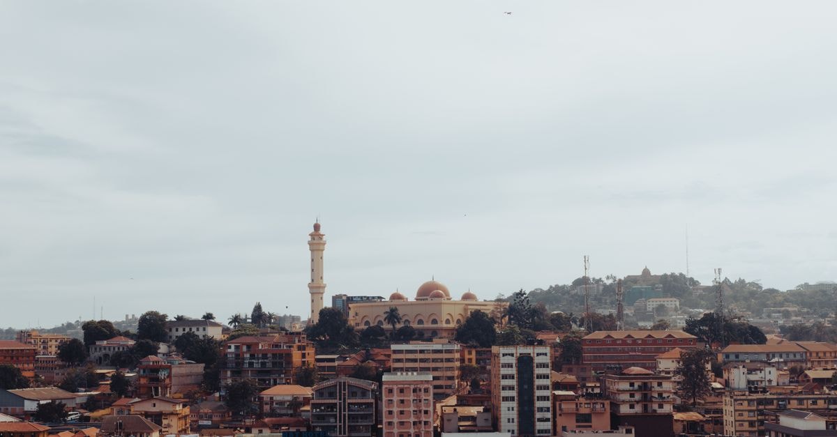 Kampala Travel Guide: Hills, Nightlife, and City Rhythm Scenic aerial view of Kampala with a beautiful mosque and urban landscape.