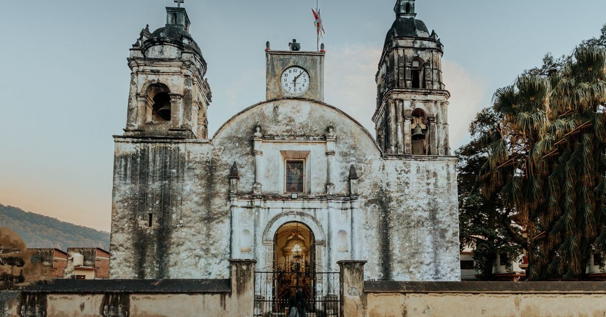 Stunning view of a historic church in Tepoztlán, Mexico, with a serene evening sky.