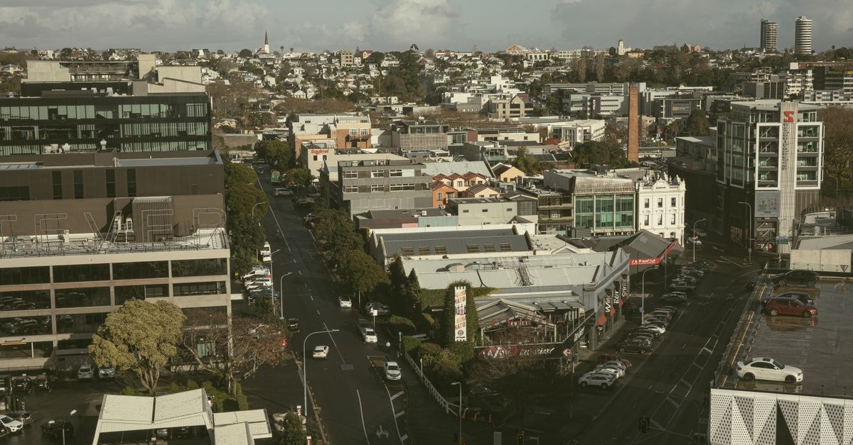 Hotel d'Urville in Blenheim: A 1920s Art Deco Boutique Stay Aerial view of modern cityscape in Auckland, showcasing streets and architecture.