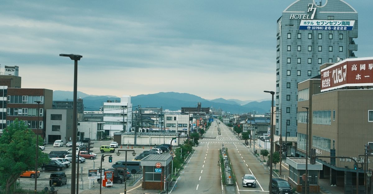 Matsumoto Hotel Kagetsu, Matsumoto — A Storied Stay Since 1887 A wide shot of Takamatsu city with overcast skies and a central road view from above.