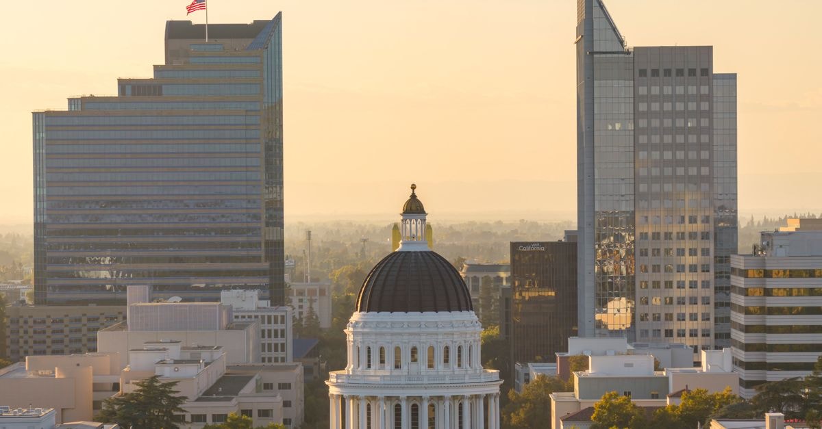 Aerial view of Sacramento skyline with the iconic California State Capitol building at sunset.