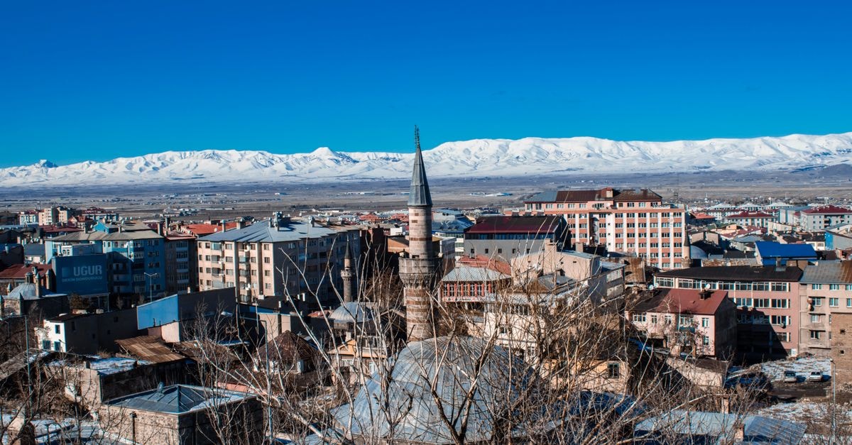 Maragheh Travel Guide: History, Sahand Views, and Local Flavor Aerial view of Erzurum, Türkiye showcasing the cityscape with snow-capped mountains in the background.