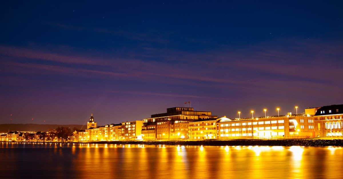 Breathtaking night view of Jönköping's illuminated waterfront reflecting on Lake Vättern.