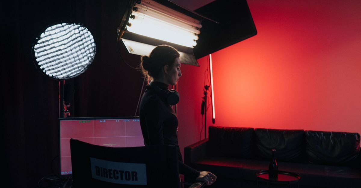 HBO Max's 'Lanterns' draws mixed verdicts as Kyle Chandler and Aaron Pierre take on a gritty Green Lantern detective drama A director in a studio setting with lighting and equipment, creating a cinematic atmosphere.