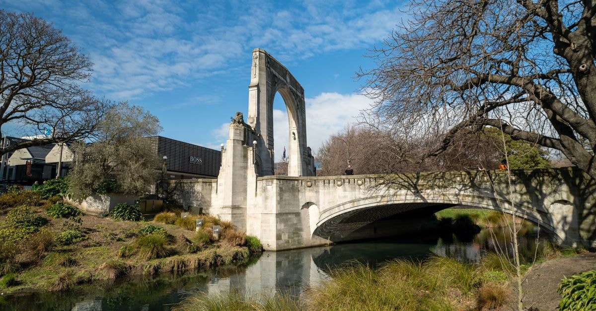 Scenic view of the Bridge of Remembrance in Christchurch, New Zealand, spanning the Avon River.