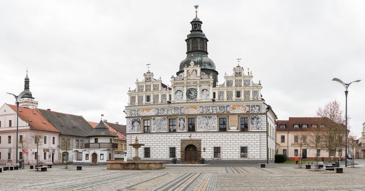Hotel 100 in Pardubice: A Castle-View Stay in the Old Town Panoramic view of a historic town square featuring ornate Renaissance buildings and cobblestone pavement.