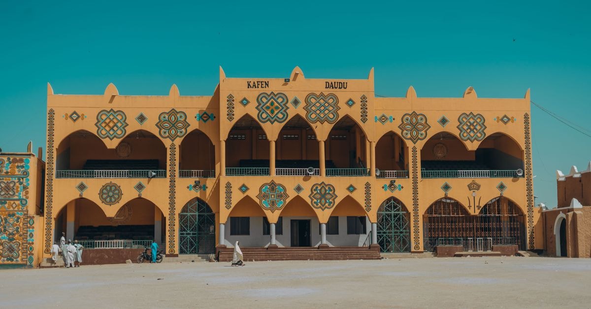 A colorful building with unique architectural designs in a desert landscape.