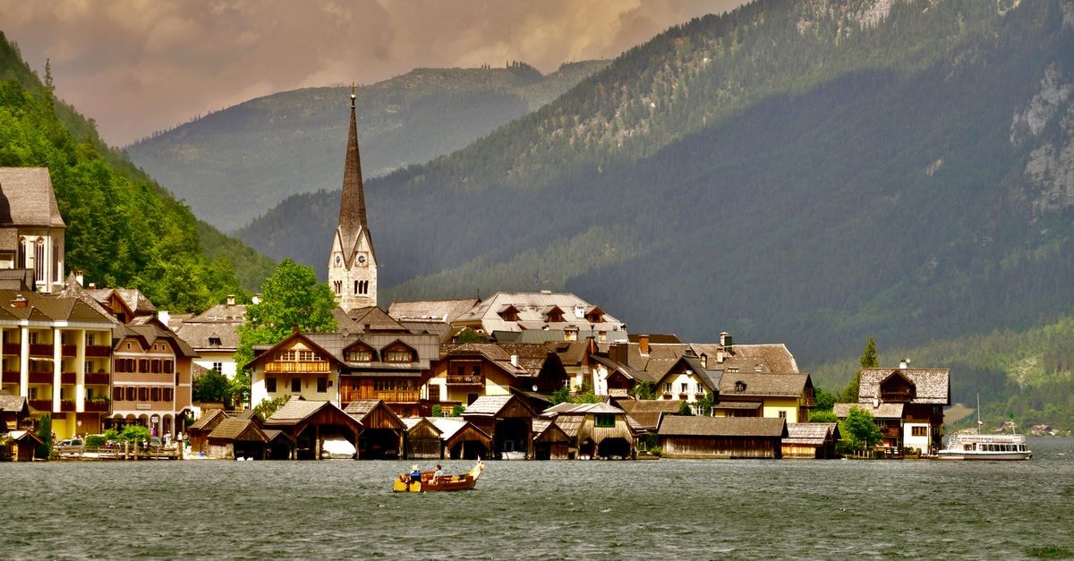 Hallstatt Travel Guide: Planning Tips, Costs and Things to Do Stunning landscape of Hallstatt village by the lake with mountains in Austria.