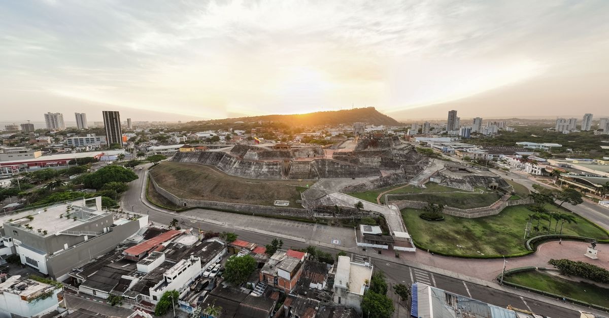 Drone view capturing the scenic sunset over the historic fortress in Cartagena.