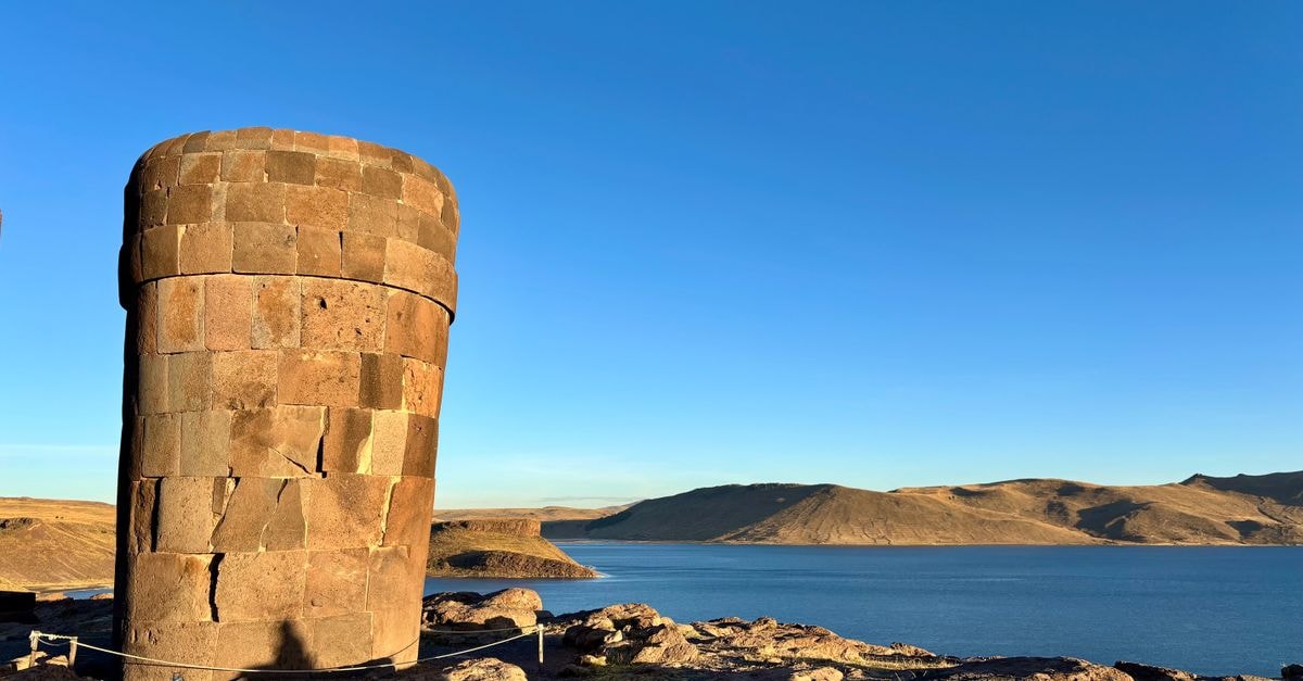 Mosoq Inn in Puno: Modern Stay Near Lake Titicaca Scenic view of Sillustani stone tower against a blue sky beside Lake Umayo in Puno, Peru.