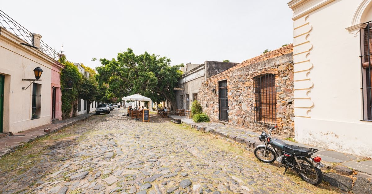 Treinta y Tres Travel Guide: Slow Days in Uruguay's Quiet East Explore the historic charm of a cobblestone street in Colonia, Uruguay, showcasing unique architecture.