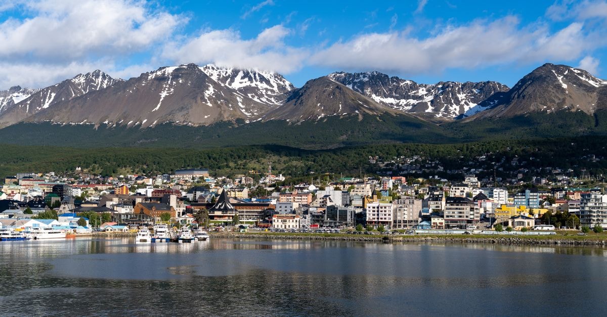 Discover the stunning cityscape of Ushuaia, Argentina with snow-capped mountains as a backdrop.