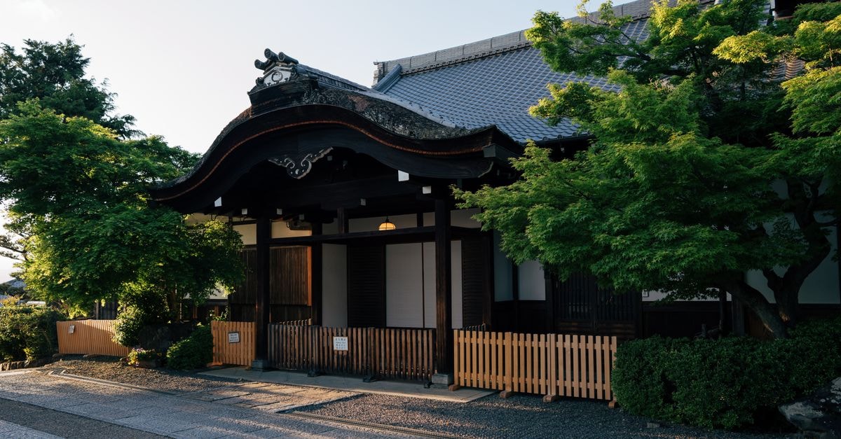 Scenic view of a traditional Japanese temple in Kyoto with lush greenery and classic architecture.