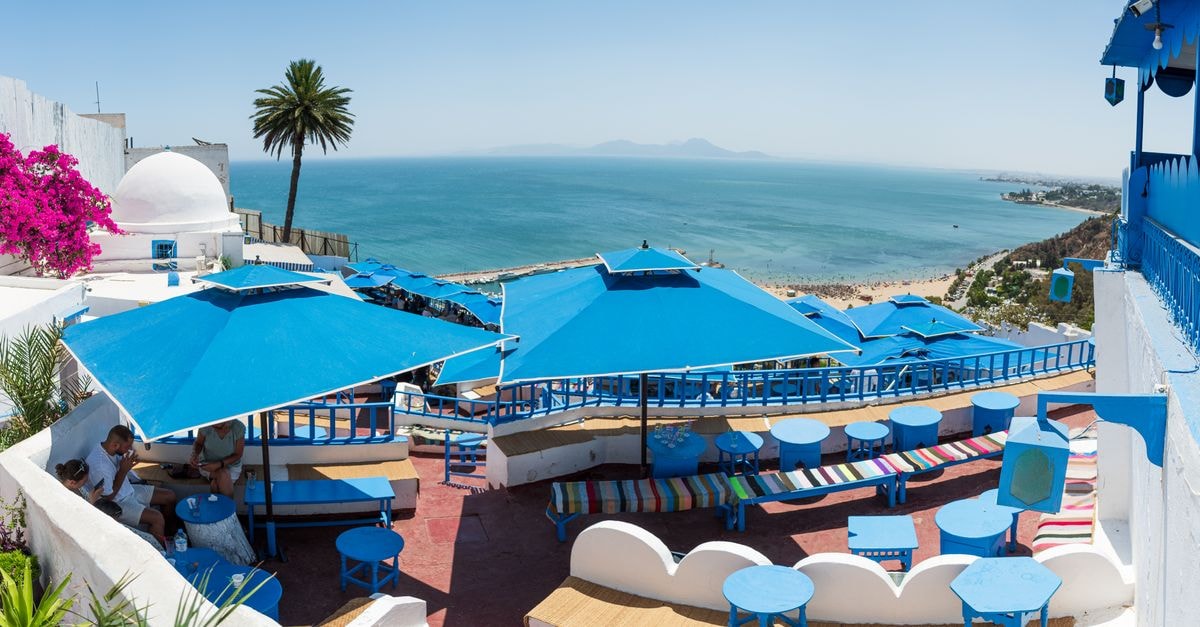 Hôtel du Lac in Tunis: A Brutalist Landmark Worth Knowing Discover a colorful seaside terrace in Carthage, Tunisia, offering stunning Mediterranean views for a perfect vacation retreat.