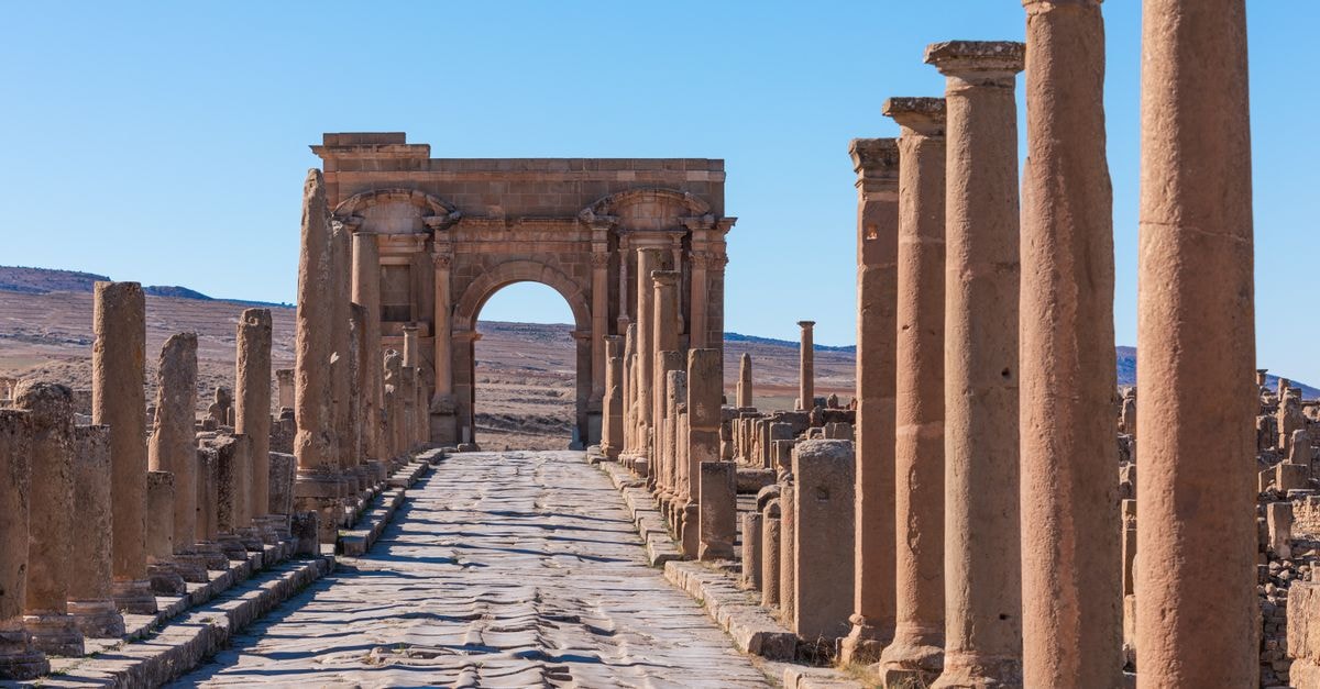 Tlemcen travel guide: uncovering Algeria's quiet historic gem Explore the majestic ancient Roman ruins with towering stone columns under a clear blue sky.