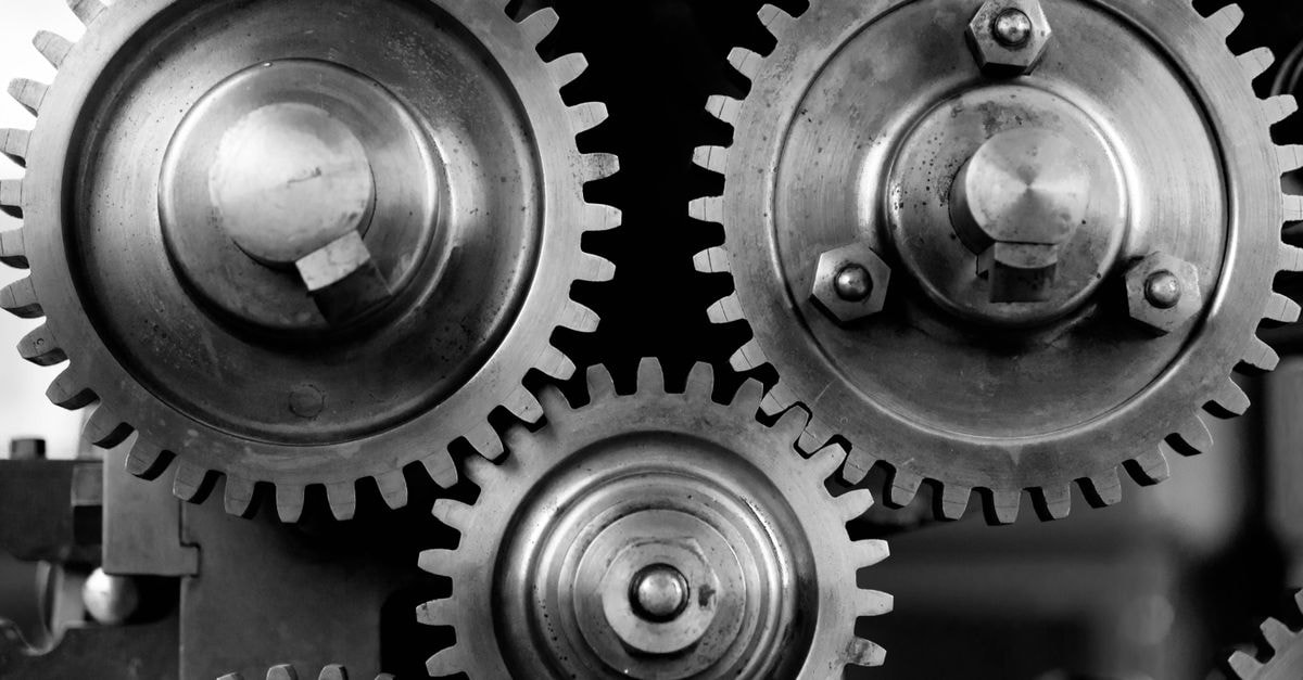 Detailed black and white image of interlocking metal gears showcasing industrial mechanics.
