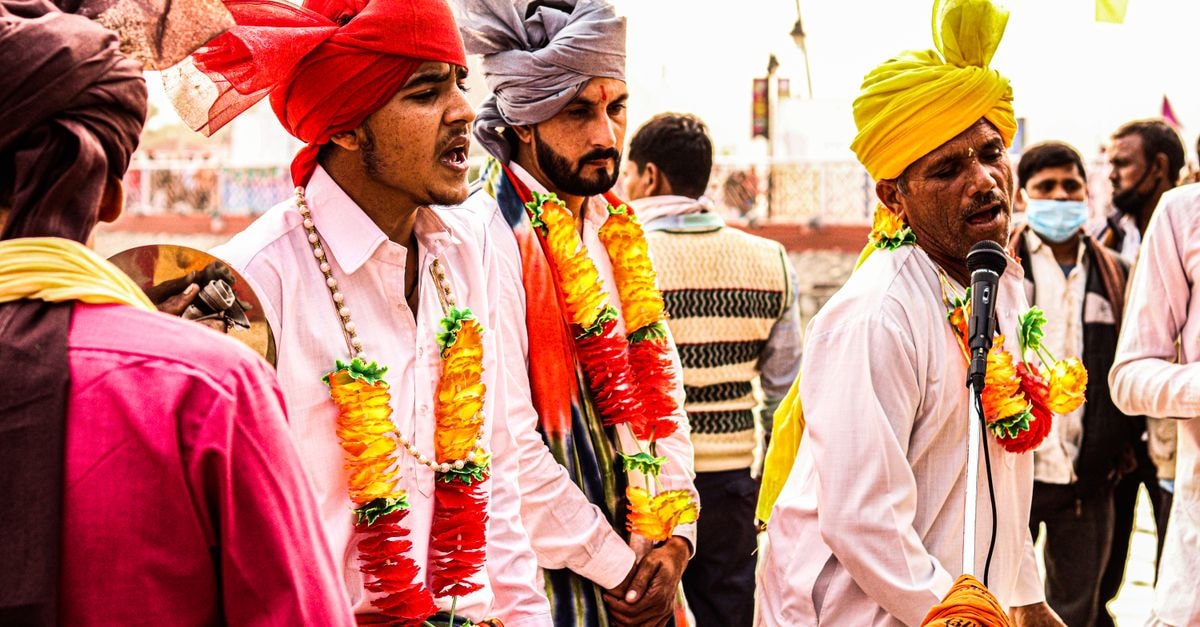 Celebration in Kulti: Grand Halls, Lawn and Rooms for Big Weddings Colorful celebration with traditional musicians in festive attire.