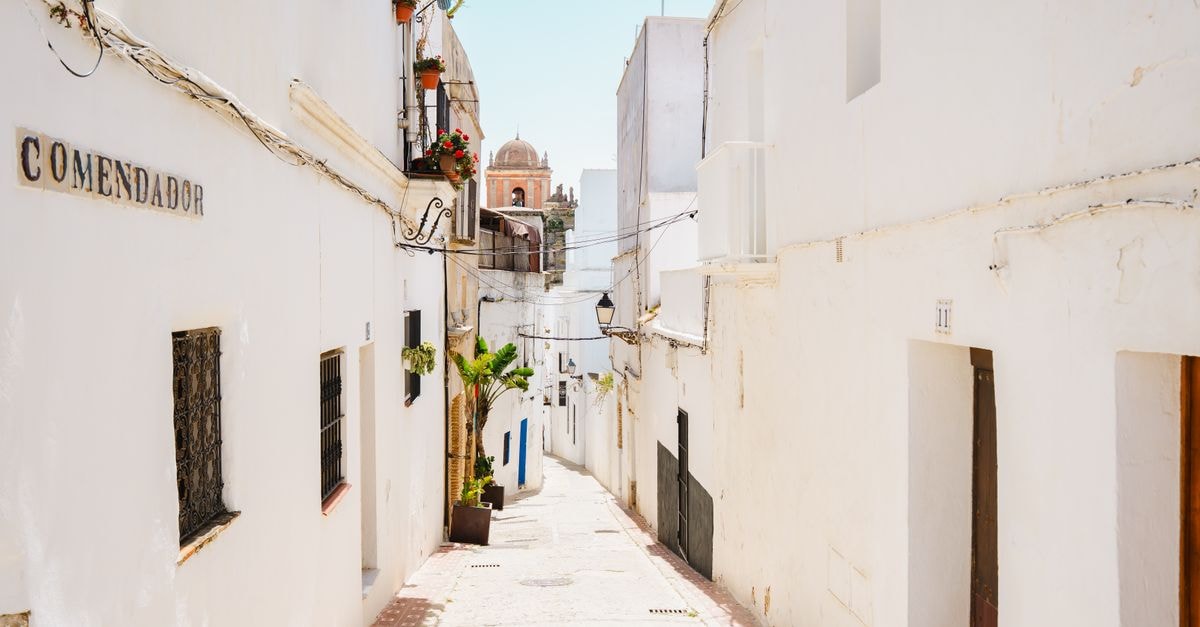 A sunlit view of the iconic white streets in Tarifa, Andalusia, Spain, embodying Mediterranean charm.