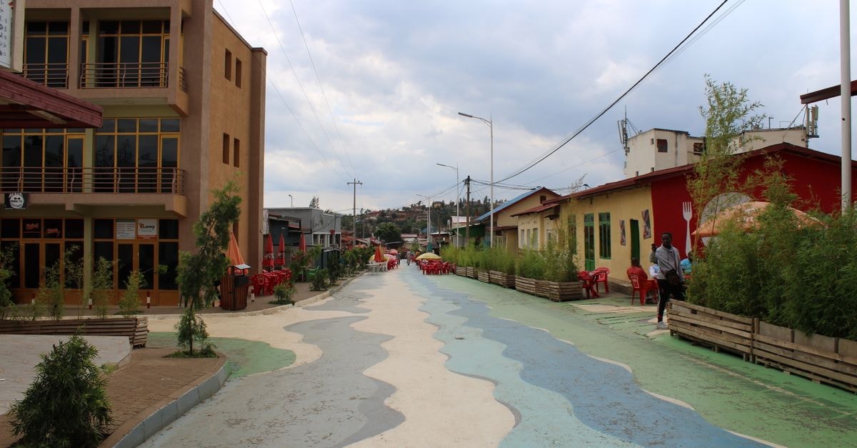 Antananarivo Travel Guide: Things to Do, Eat and Navigate Dynamic street scene in Nyamirambo, Kigali with colorful architecture and vibrant patterns.
