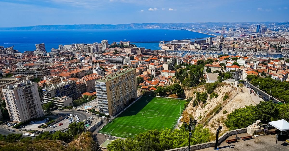 Hotel Marsiho by HappyCulture in Marseille: A Sunny Mediterranean Base on Cours Belsunce A stunning aerial view of Marseille, France, showcasing the city's skyline and the Mediterranean Sea.