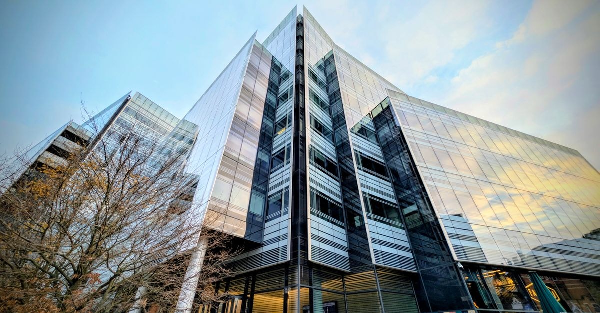 Glass facade of a modern building in London, showcasing contemporary design and urban development.
