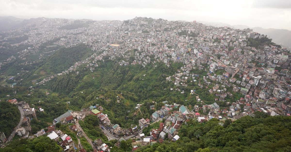 Scenic aerial view showcasing the sprawling city of Aizawl nestled among lush hills in Mizoram, India.