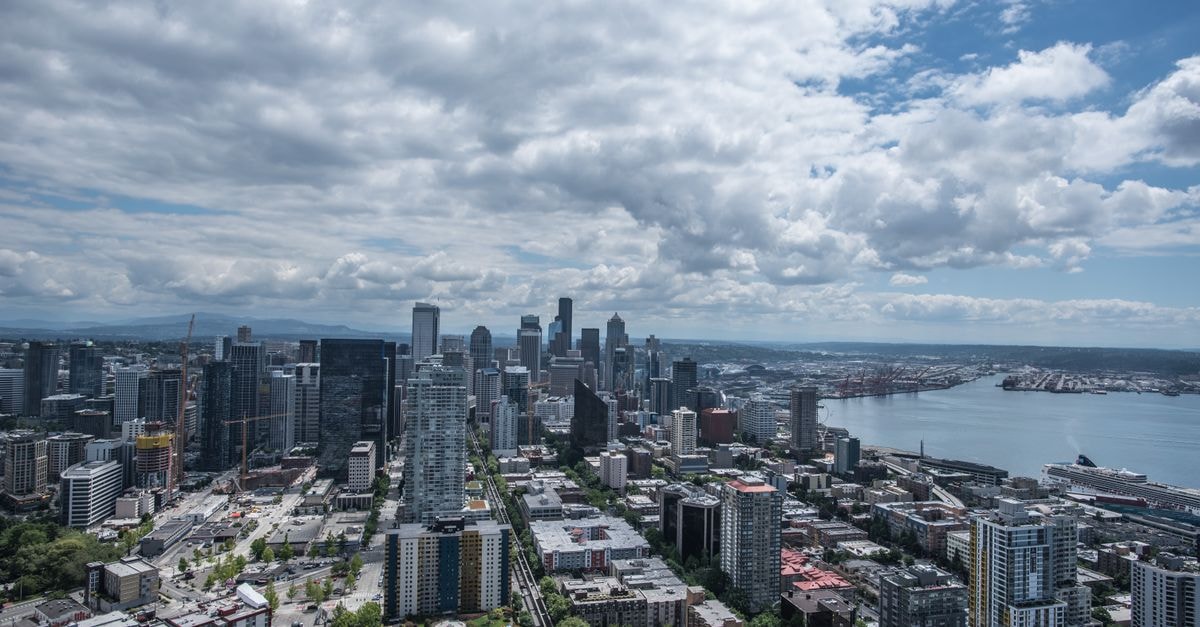 W Hotel Seattle in Downtown Seattle: Pacific Northwest Design with a Recording Studio Aerial view of Seattle's skyline with Puget Sound in the background on a cloudy day.