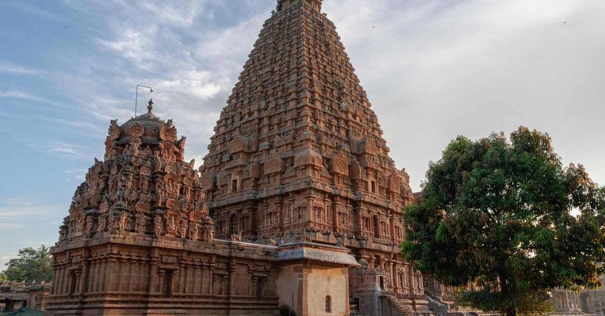 Stunning view of the Brihadeeswarar Temple in Thanjavur, India during sunrise, capturing its intricate Dravidian architecture.