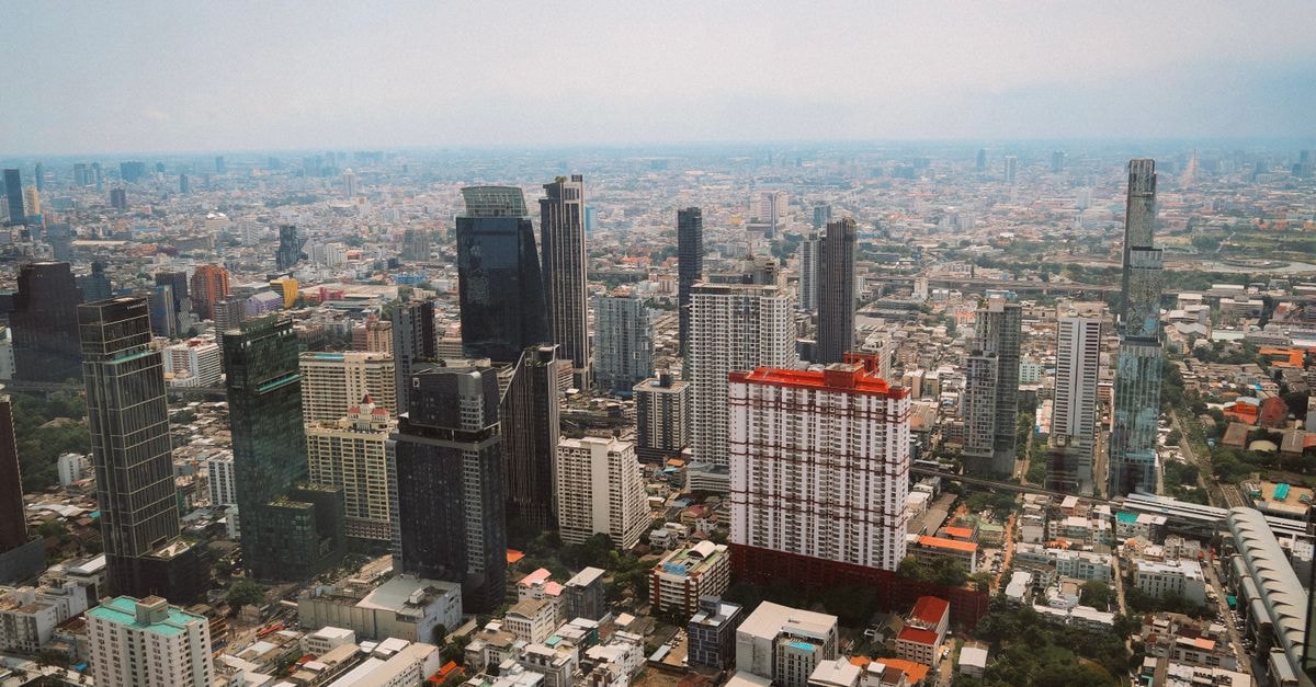 Oh Compound Hostel, Bangkok — A Fresh Stay in the Khaosan District Stunning aerial photograph showcasing Bangkok's dynamic skyline under daylight, highlighting modern skyscrapers.