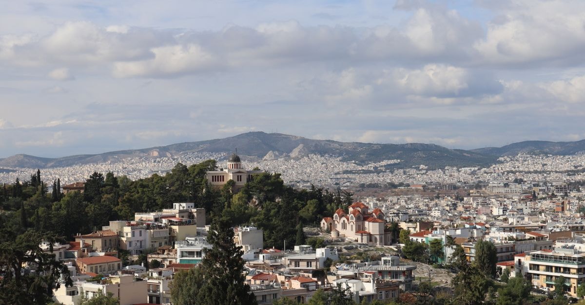 Amalia Athens: Central Stay Overlooking the Greek Parliament A stunning aerial view of Athens featuring Areopagus Hill and the cityscape. Perfect for travel and urban enthusiasts.