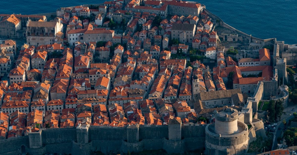 Villa Elly in Dubrovnik: a Sun Terrace with Sea Views in Boninovo Breathtaking aerial shot of Dubrovnik's historic Old Town, showcasing ancient city walls and red-tiled roofs.