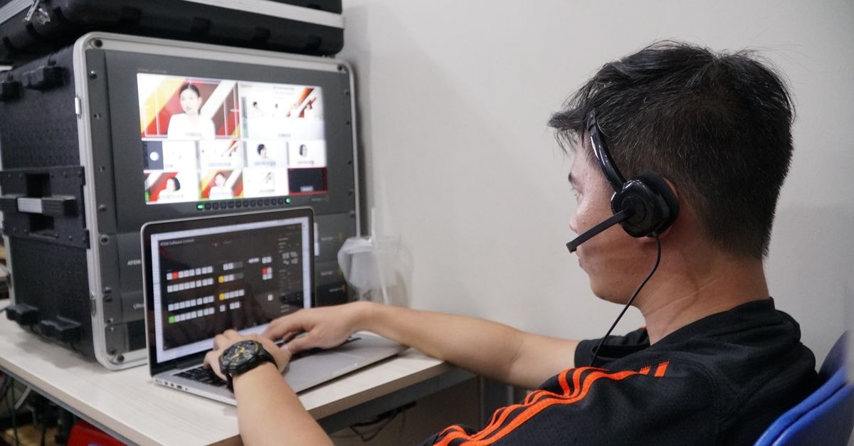 The Last House Tops Netflix's Weekly Charts as Walter Boys Returns Technician manages multiple video feeds using laptop and monitor in studio setting.