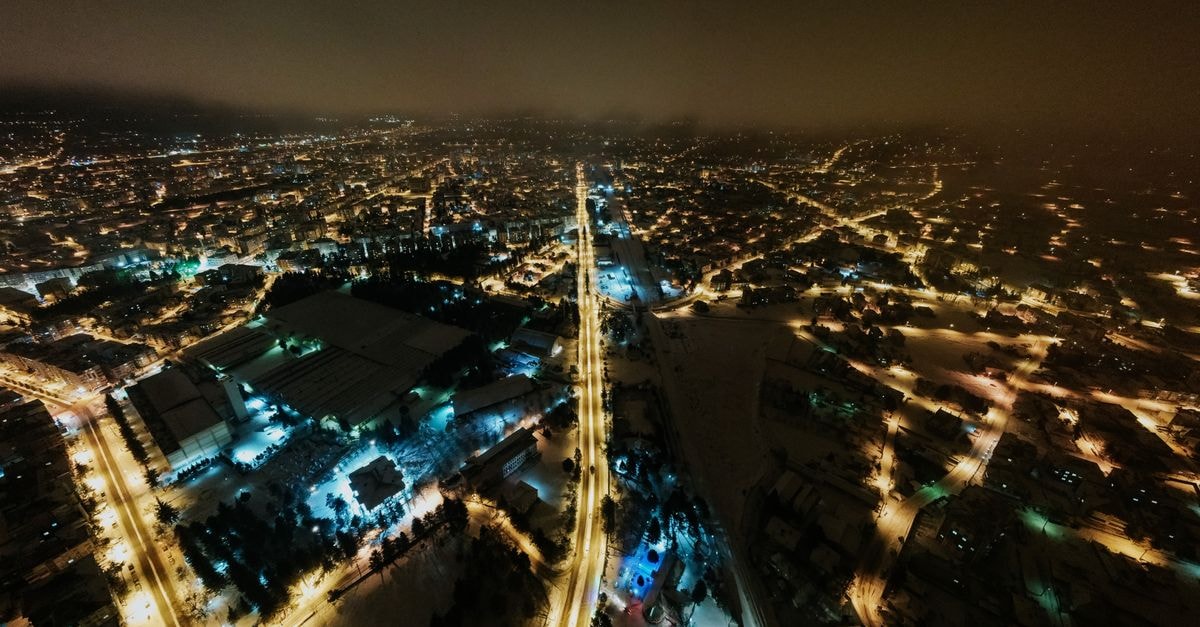 Asam Hotel in Kerman: City-Center Stay Near Azadi Square A stunning aerial view of a city's illuminated streets at night, showcasing the vibrant urban landscape.