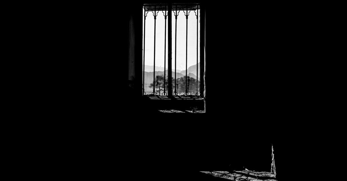 Fadak Hotel in Qom: Apartment Stay Near the Shrine Monochrome shot of a window silhouette overlooking mountains, exuding a dramatic and moody atmosphere.