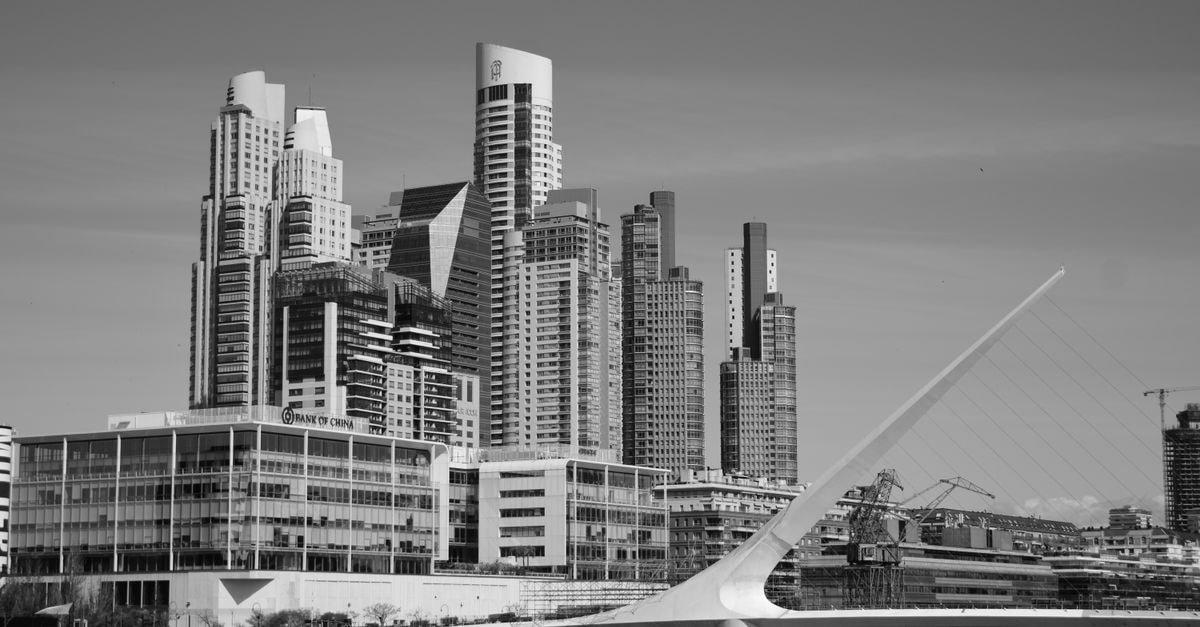Black and white view of modern Buenos Aires skyline with the iconic Puente de la Mujer.