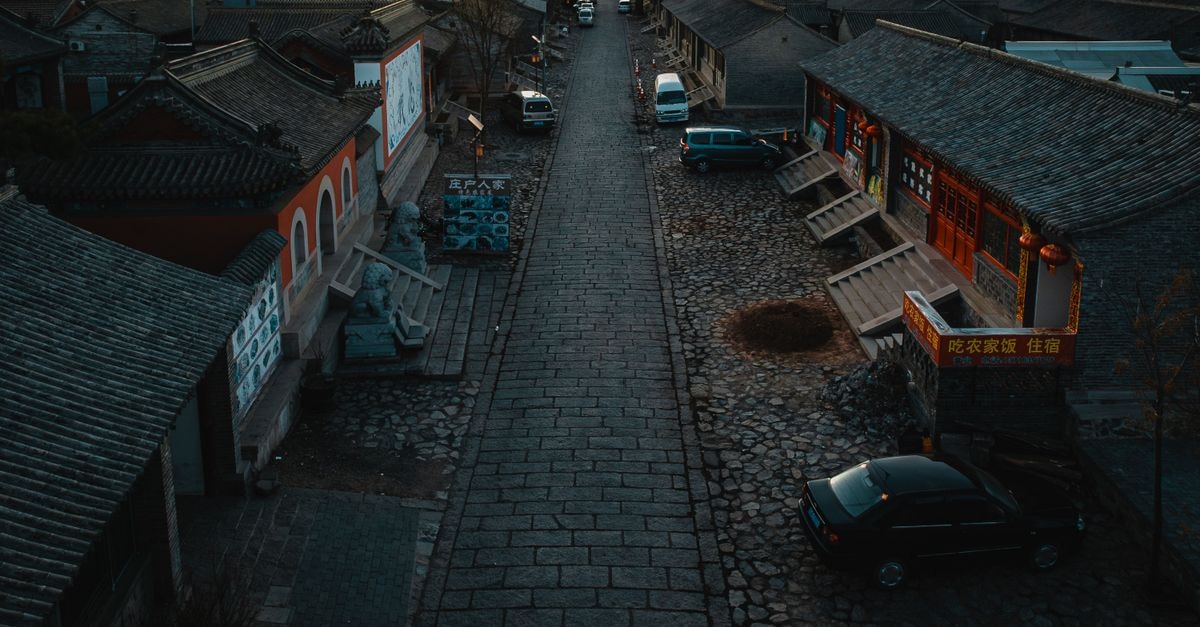 Pingyao Fu Lin Yuan Inn in Pingyao: A Courtyard Stay Near Ancient Temples Quiet cobblestone street in a traditional Chinese village at sunset, showcasing cultural architecture.